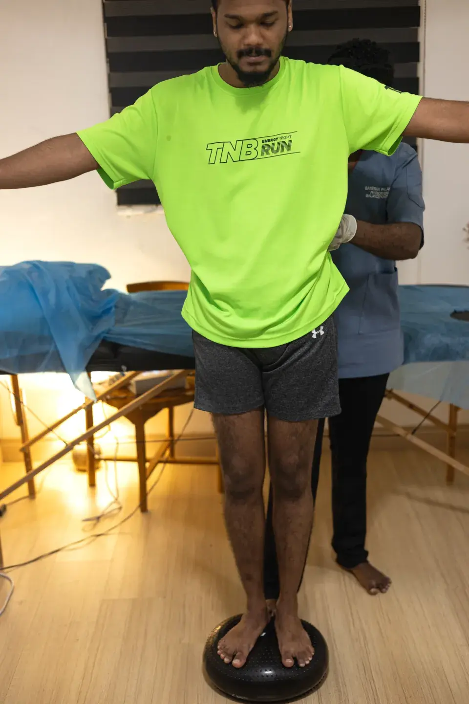 Physiotherapist supervising a patient during a balance rehabilitation exercise